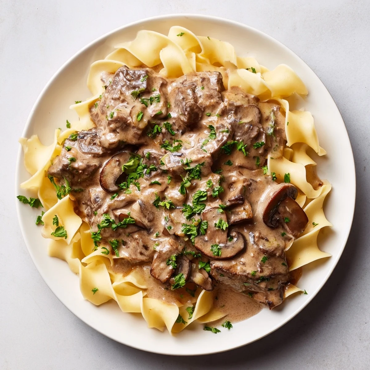 Close-up of savory beef stroganoff, showcasing the tender beef and creamy mushroom sauce.