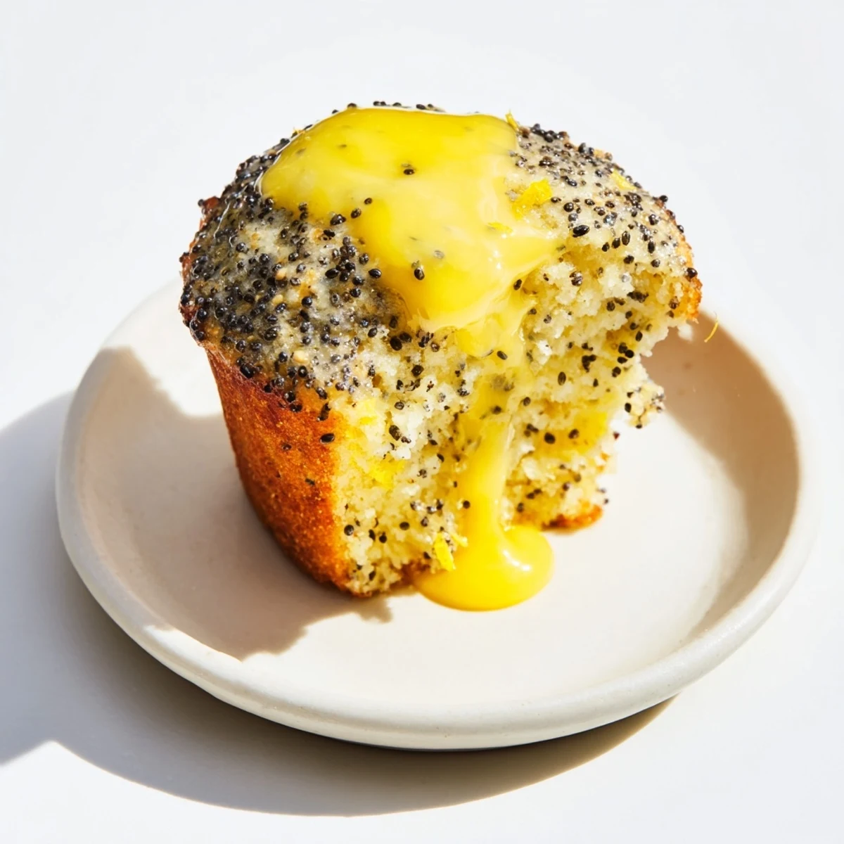 Fluffy Lemon Poppy Seed Muffins with a glistening lemon glaze, perfect for a sunny breakfast.