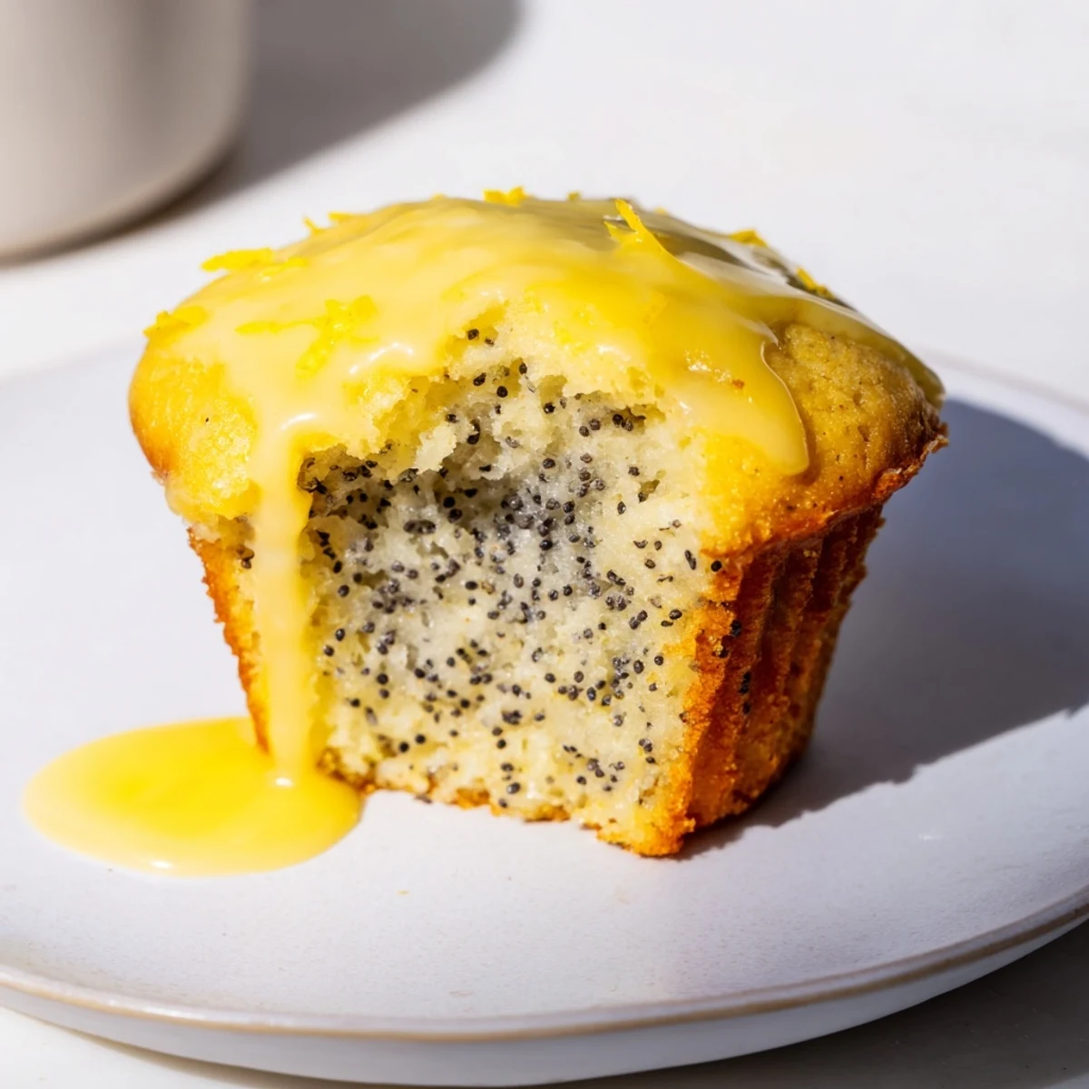 Golden, moist Lemon Poppy Seed Muffins, drizzled generously with a sweet and tart lemon glaze.