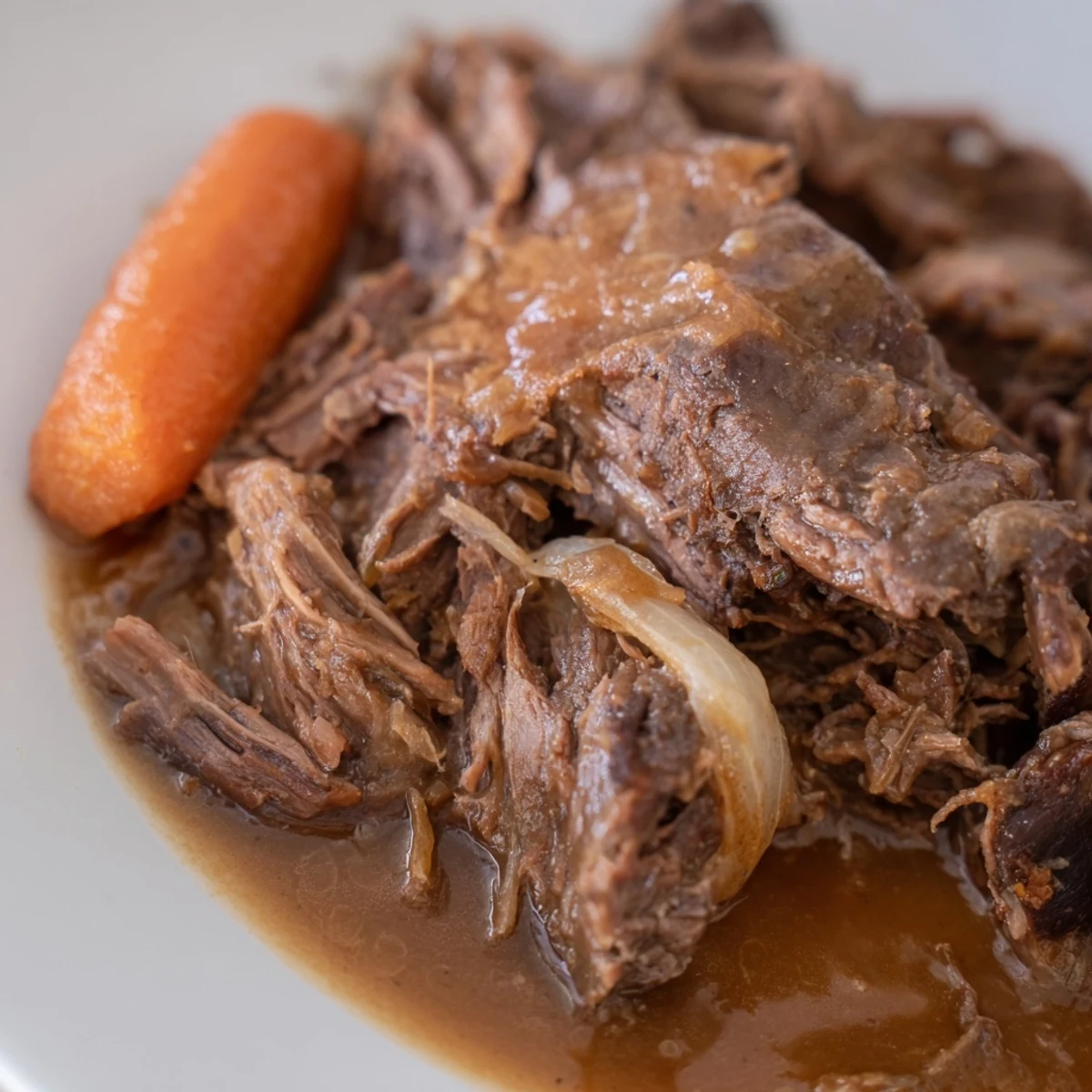 Slow Cooker Roast Beef with Gravy is tender and juicy, served over creamy mashed potatoes for a comforting family dinner.
