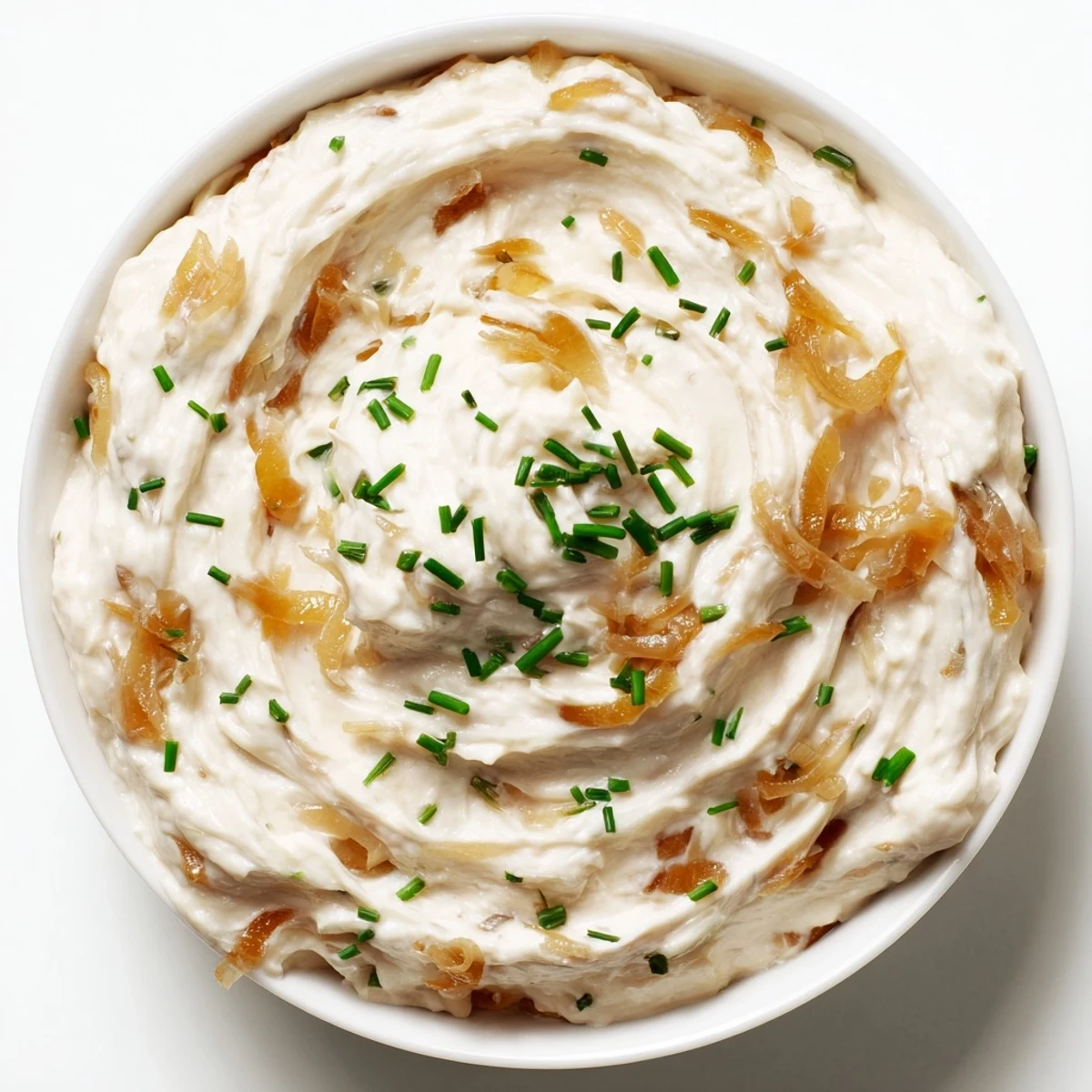 Hearty Game Day Onion Dip garnished with fresh chives, ready for snacking during football season.