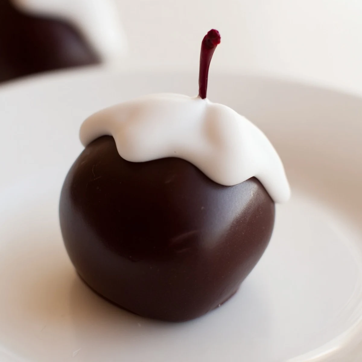 Handheld chocolate covered cherries with fondant center dipped in glossy chocolate, ready to serve at a festive party.