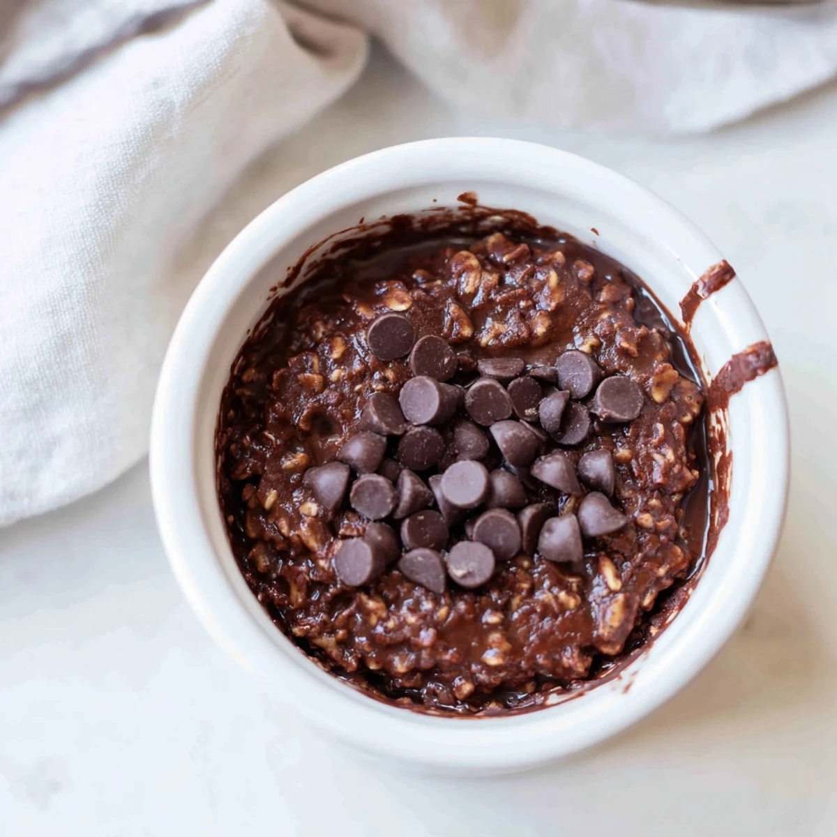 Easy Chocolate Baked Oats served warm in a small dish for a cozy breakfast.