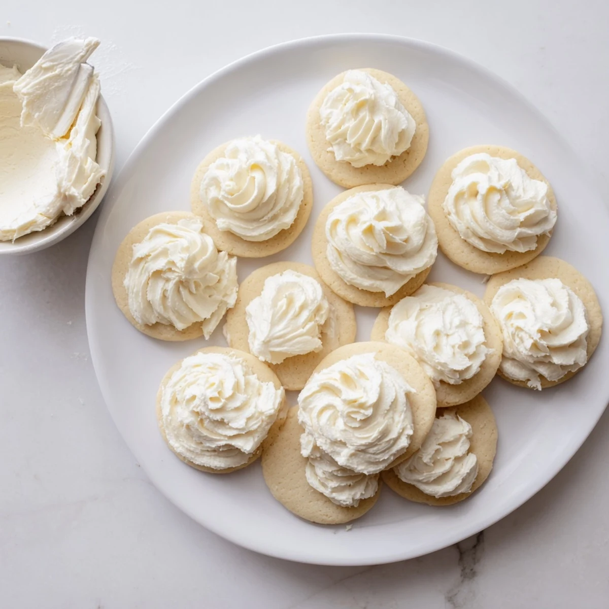 Homemade Easy Sugar Cookie Frosting spread on cookies with a smooth, glossy finish.