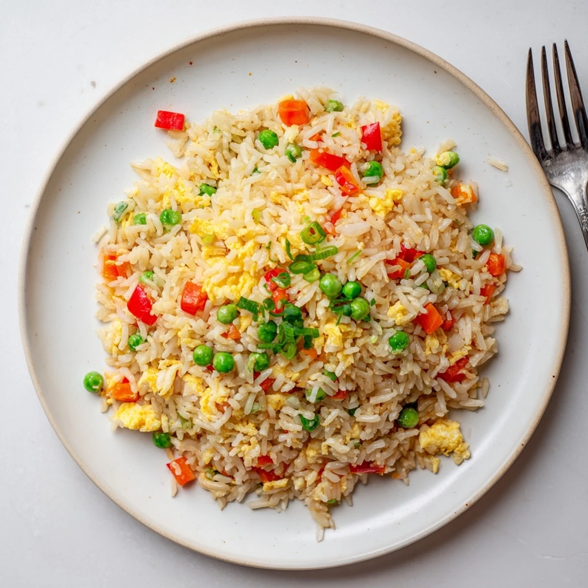 Homemade vegetarian Fried Rice loaded with vegetables and fluffy rice, ready to eat for dinner.