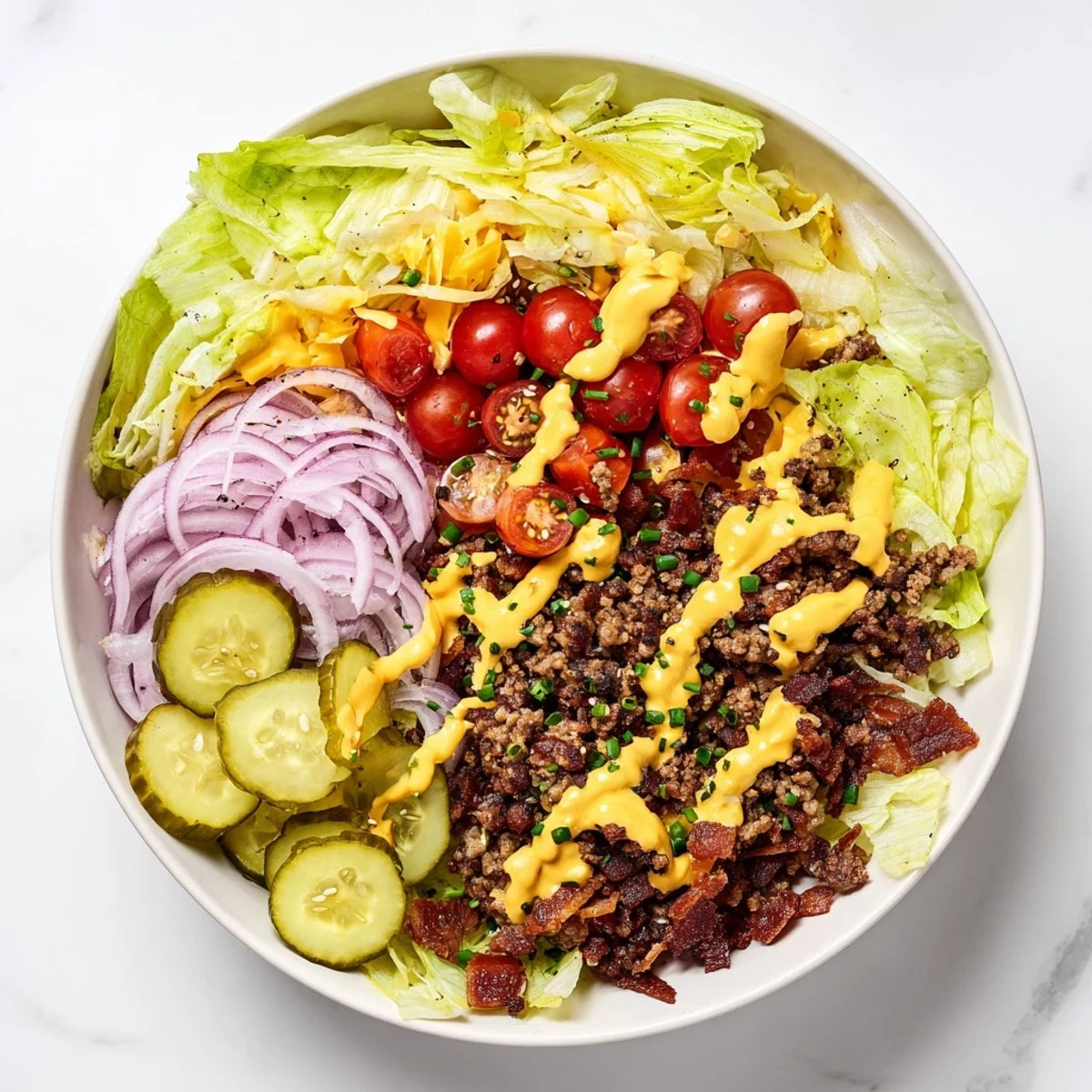 Crushed beef patty and melted cheddar in a Smash Burger Bowl with fresh pickles and onions.