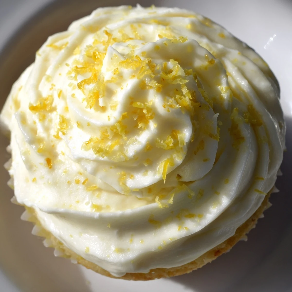Springtime Limoncello cupcakes feature moist lemon cake and a sweet, boozy frosting garnished with zest.  