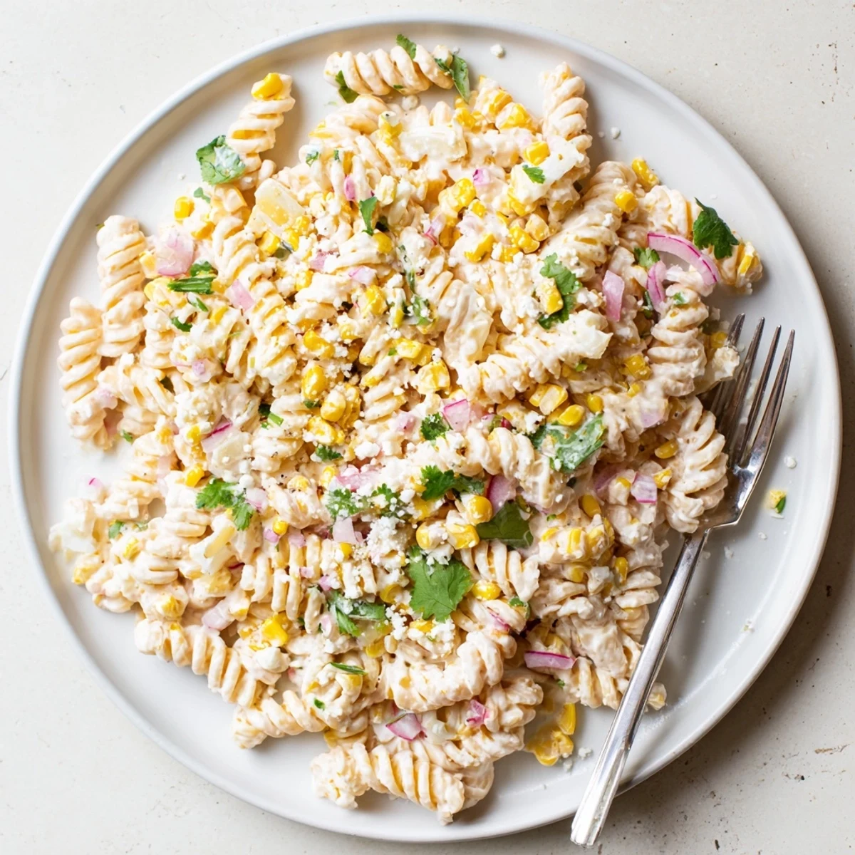 Creamy Mexican street corn pasta salad loaded with grilled corn, bell peppers and crumbled cotija cheese