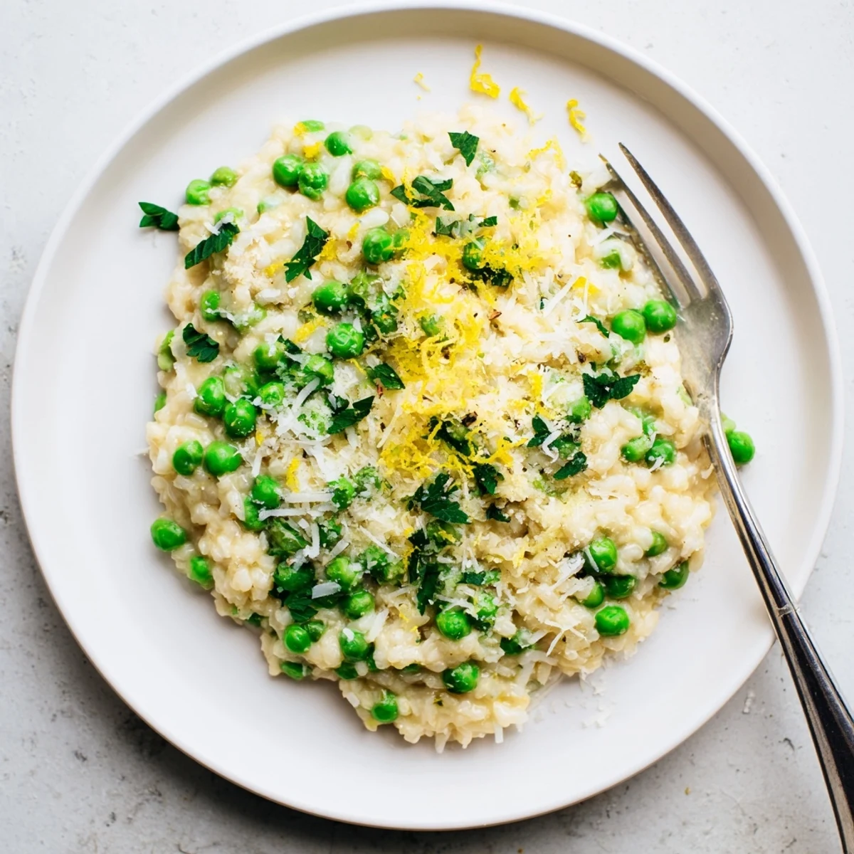 Close-up of vibrant spring pea risotto with bright green peas folded into tender Arborio rice