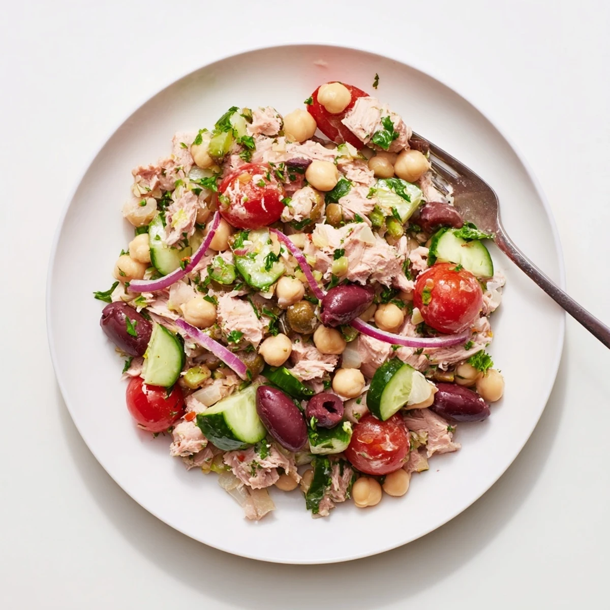 Vibrant hearty tuna and garbanzo bean salad with crisp vegetables and creamy beans drizzled with olive oil dressing