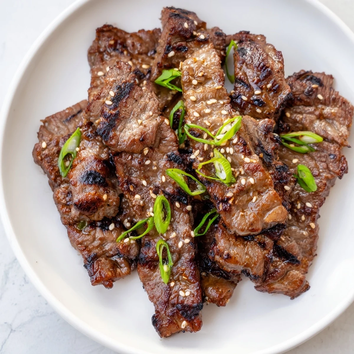 Savory grilled Galbi ribs served with steamed rice and fresh scallion toppings
