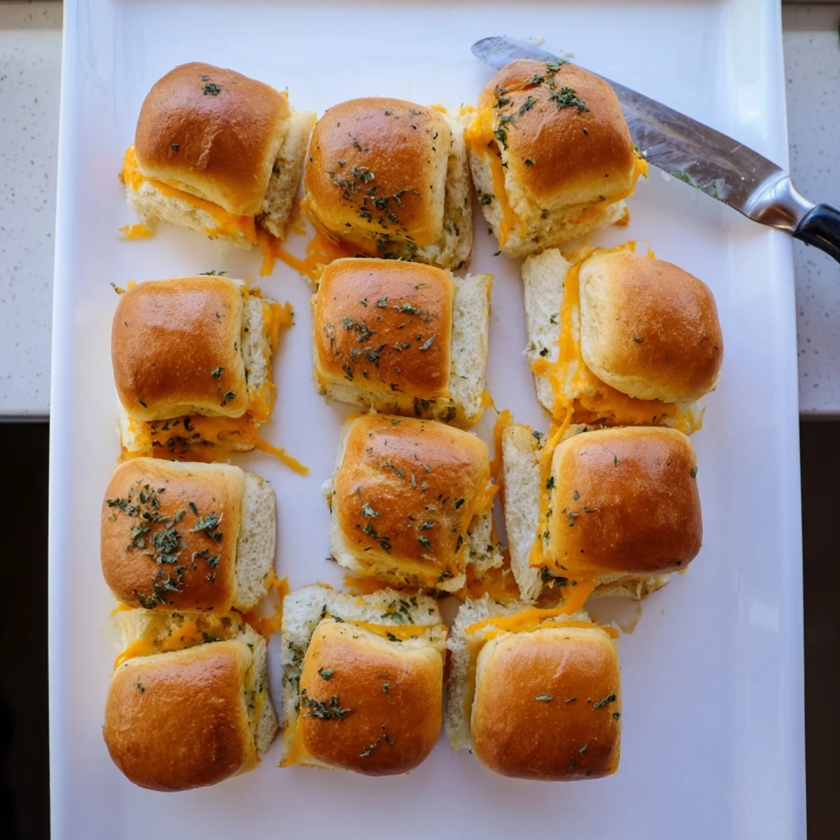 Soft sweet Hawaiian roll sliders stuffed with gooey melted cheese and brushed with garlic butter