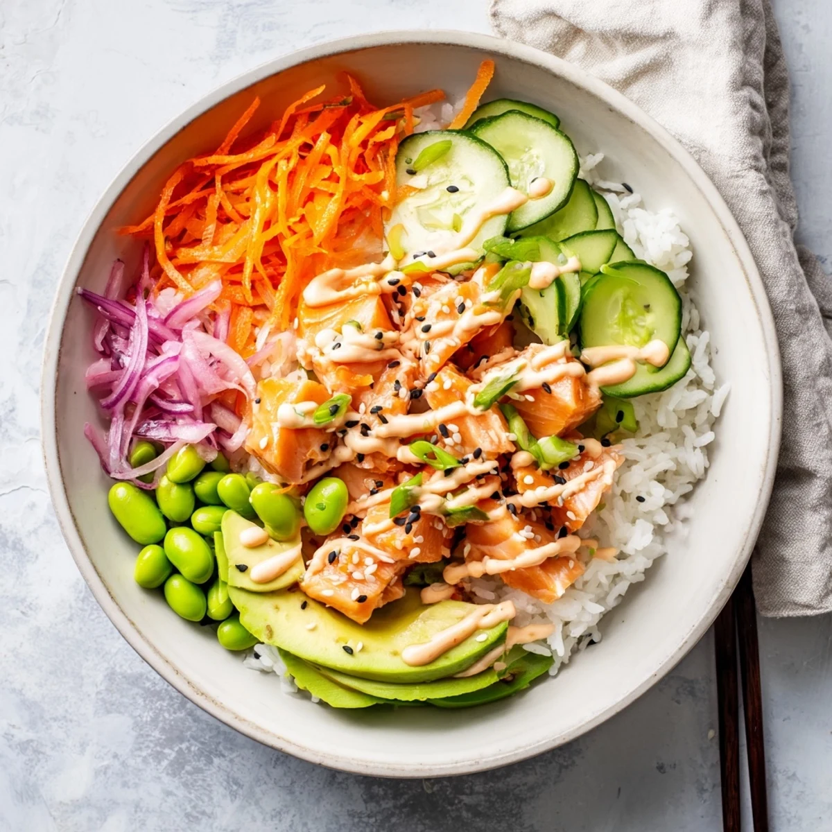 Colorful easy salmon bowl featuring tender fish, avocado slices, and zesty sriracha sauce