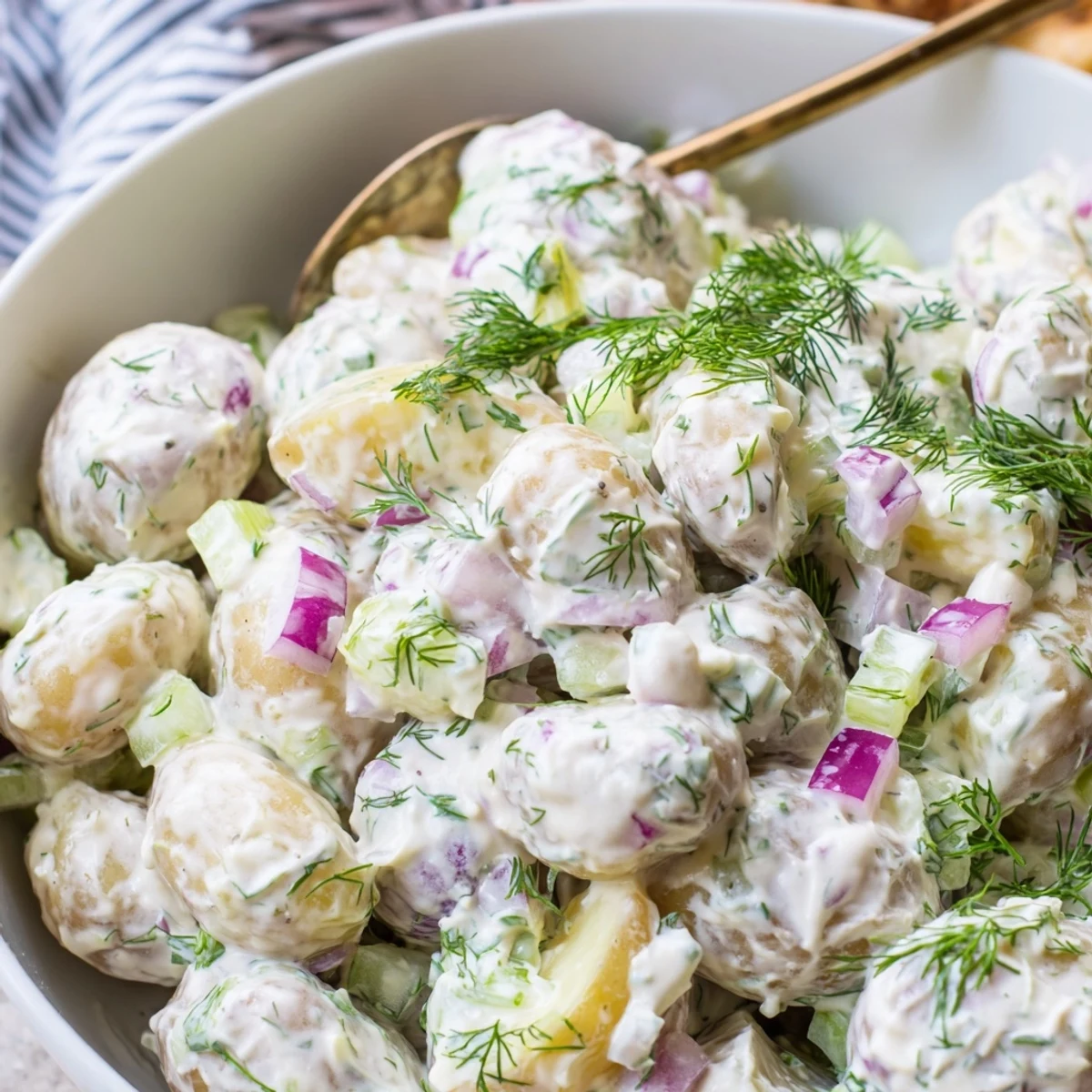 Creamy Greek yogurt potato salad tossed with fresh dill, red onion, and crisp celery