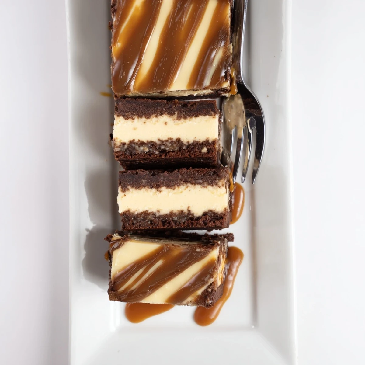 Rich caramel brownie cheesecake bliss with fudgy chocolate layers and golden caramel drizzle topping