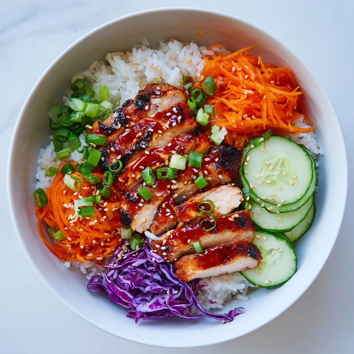 Vibrant Korean BBQ chicken bowl featuring juicy marinated meat served over rice with crunchy shredded veggies