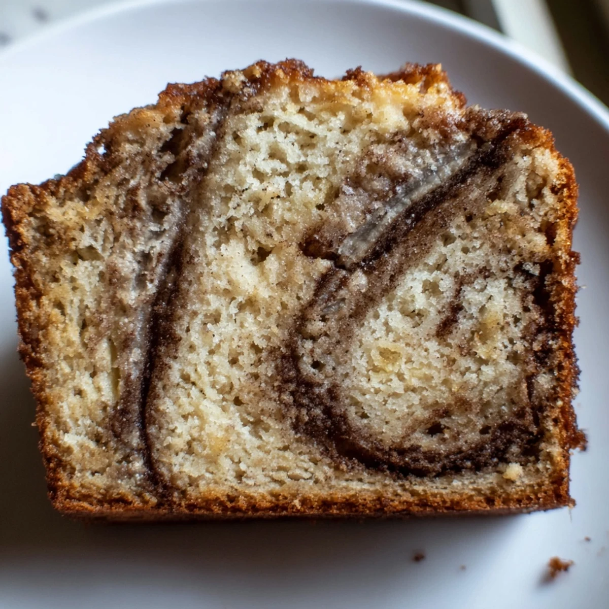 Cinnamon Sugar Swirl Banana Bread sliced thick revealing ribbons of spiced sugar throughout moist golden crumb