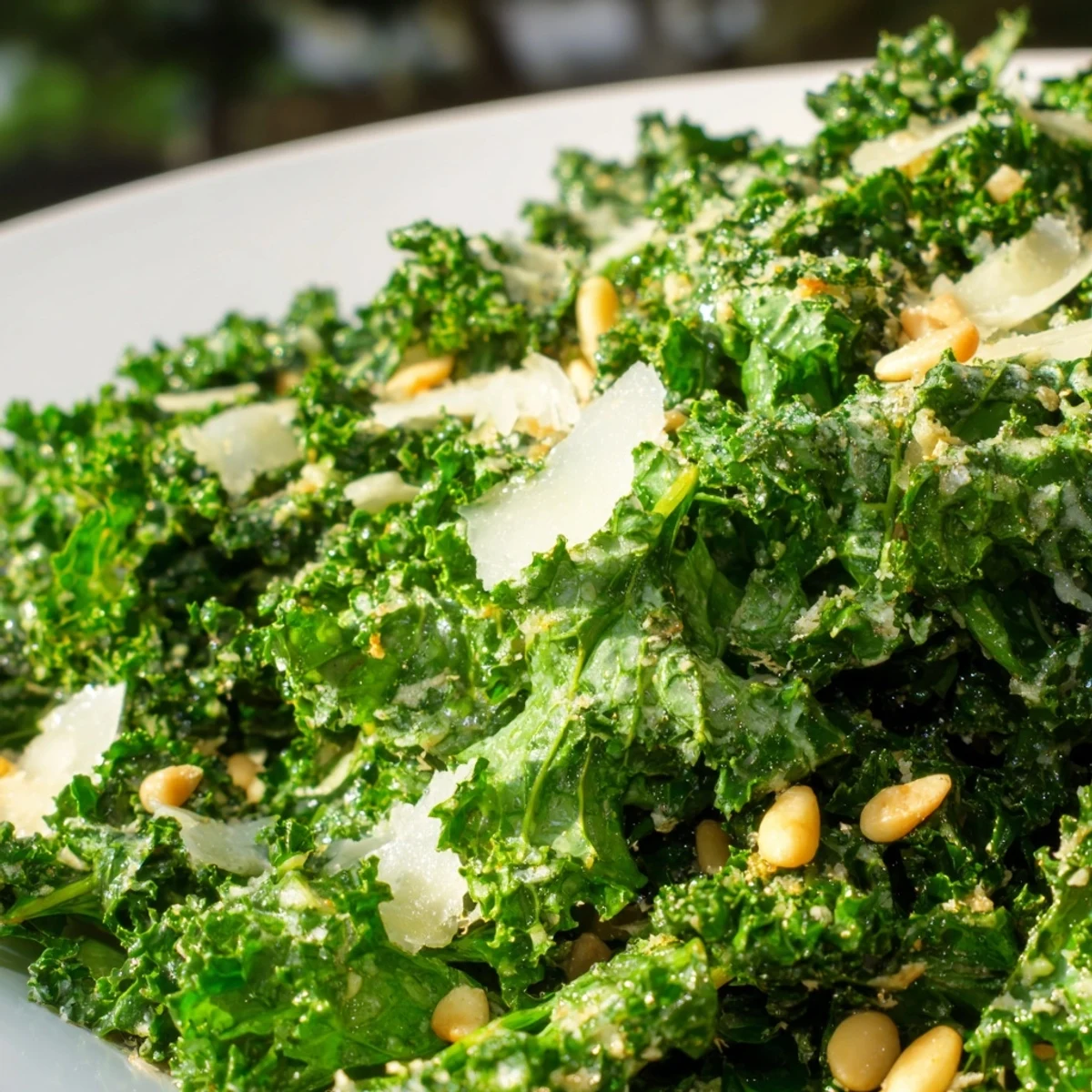 Massaged kale leaves glistening with zesty lemon garlic dressing and topped with Parmesan