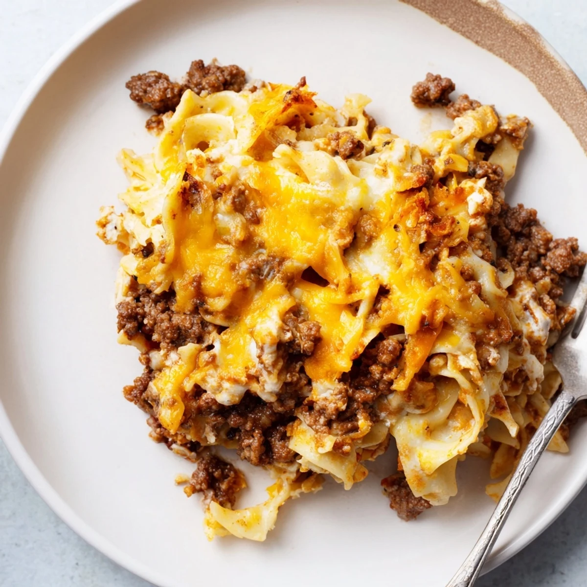 Spoonful of Beef Lombardi Casserole showing creamy cottage cheese and savory beef