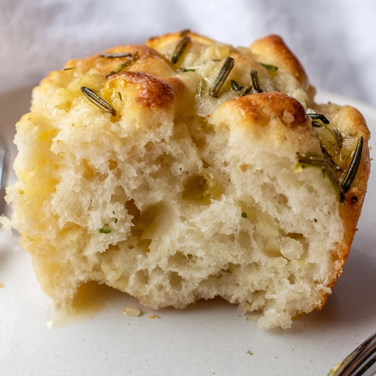 Warm Garlic Rosemary Focaccia Muffins with golden crust, fragrant herbs and olive oil