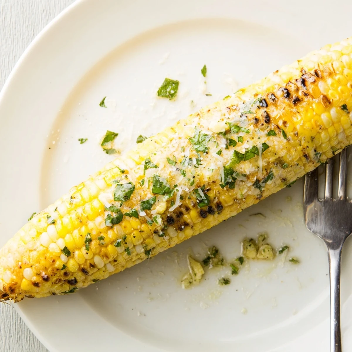 Grilled Garlic Parmesan Corn On The Cob served hot with lemon wedge  