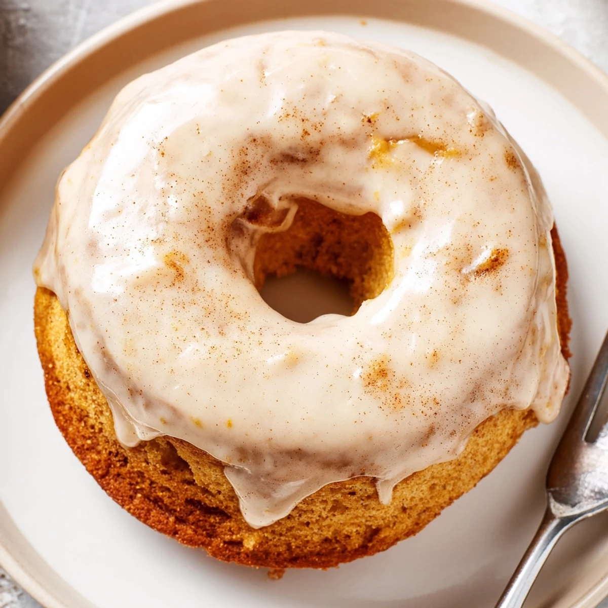 Warm Banana Donuts glazed and stacked on a wire rack, steaming.