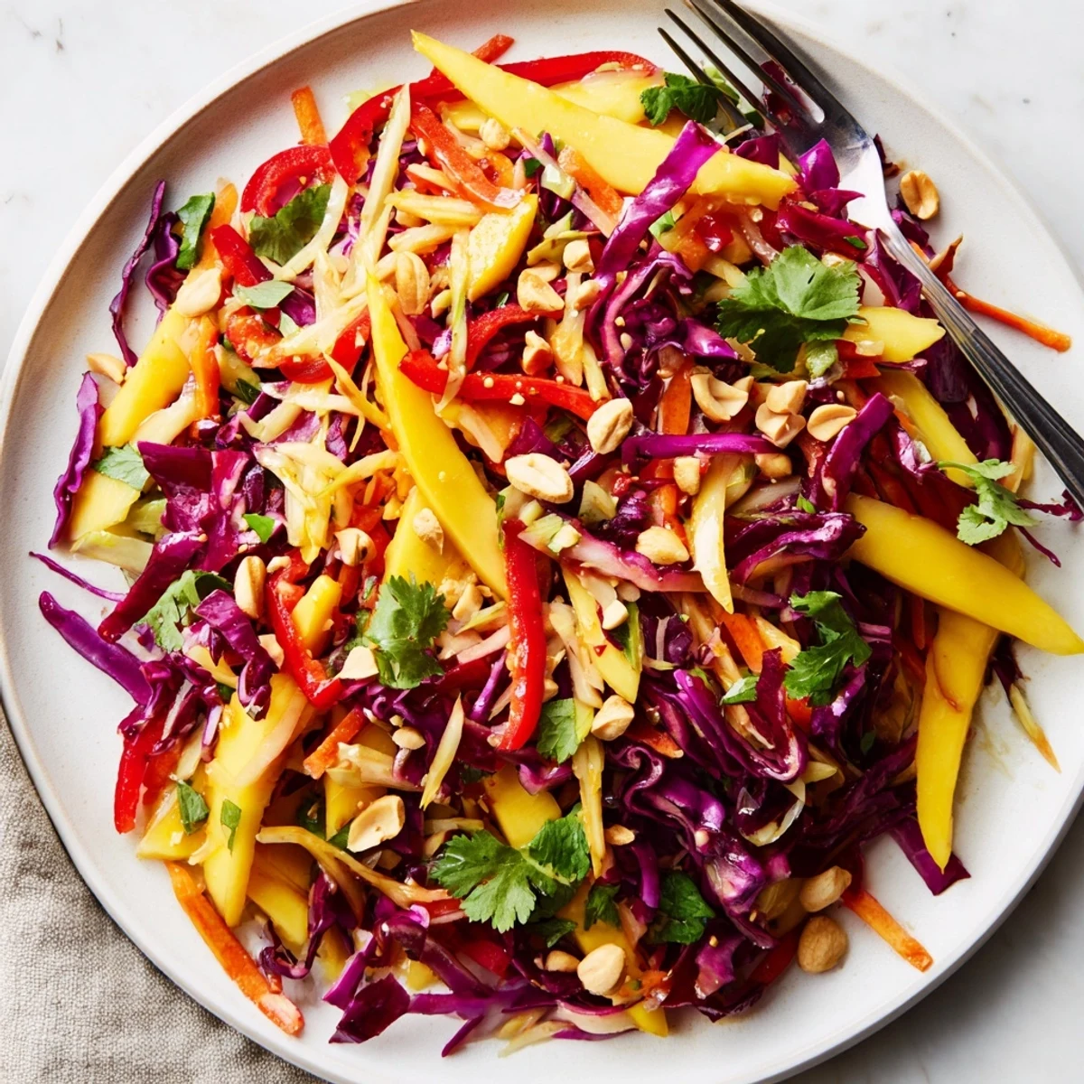 Close-up of vibrant refreshing mango slaw with crisp vegetables and tangy lime dressing.