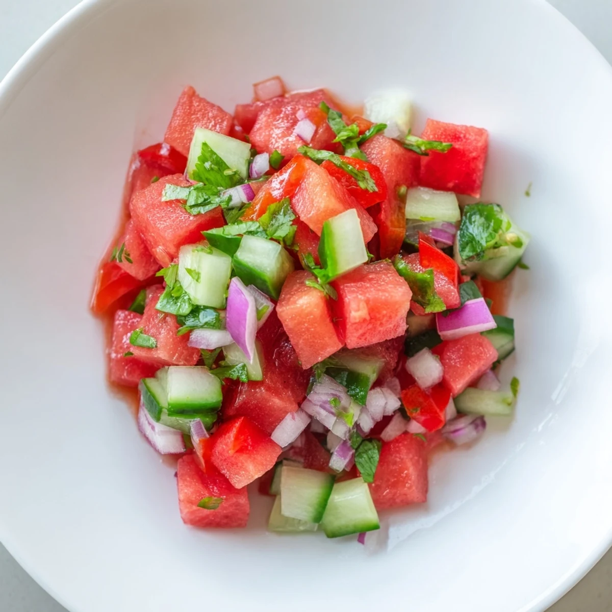 Fresh watermelon salsa with cucumber and jalapeño served alongside warm cinnamon-sugar tortilla chips