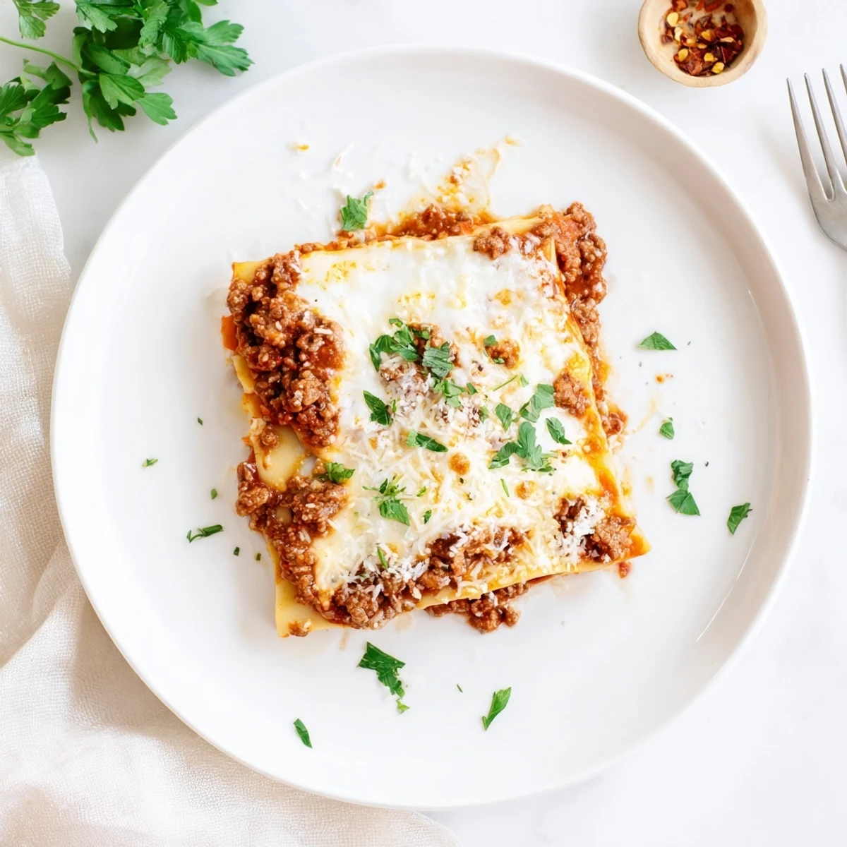 Bubbling, cheesy layers of Slow Cooker Lasagna ready for family-style serving.