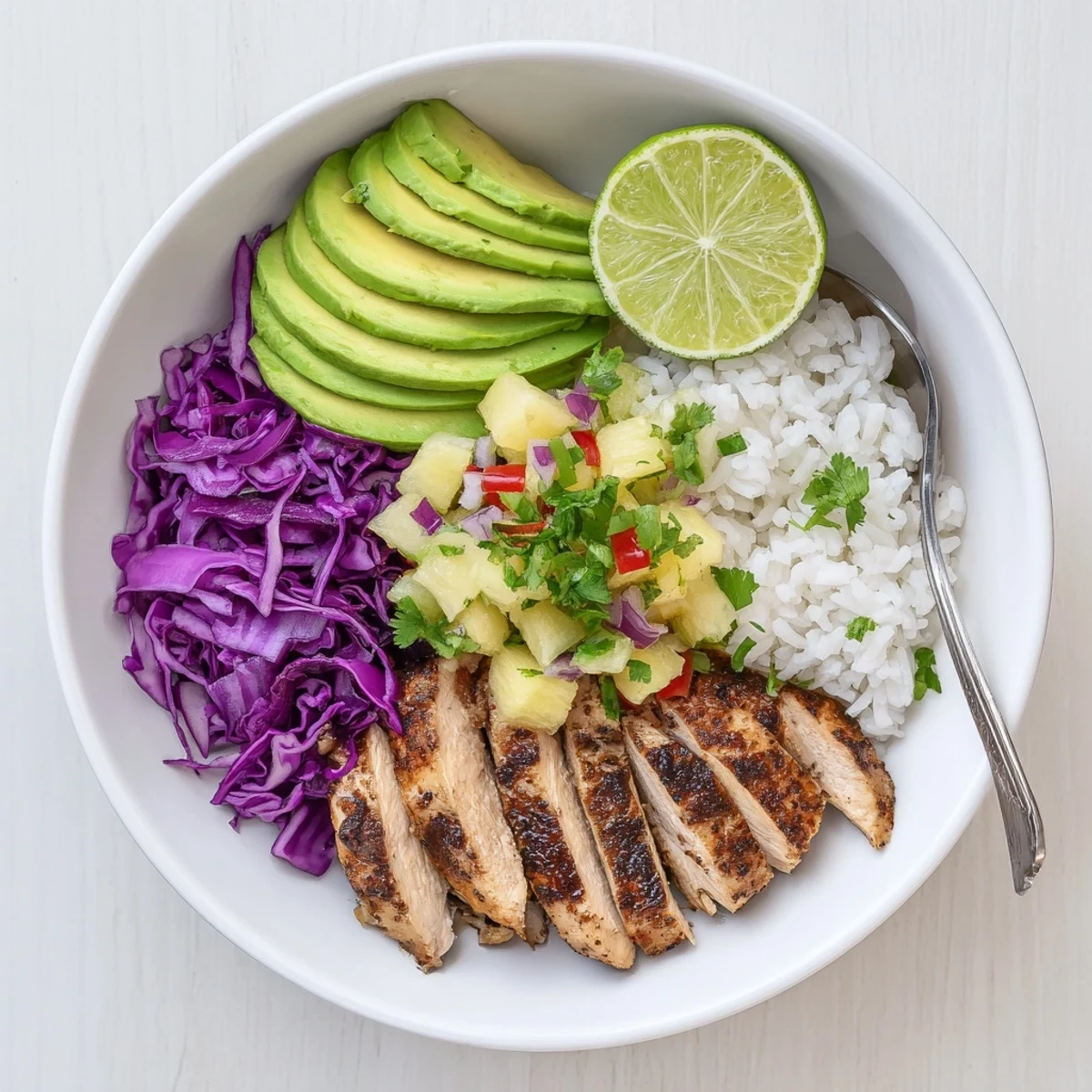 Jerk Chicken Bowl With Pineapple Salsa over fluffy jasmine rice, creamy avocado.
