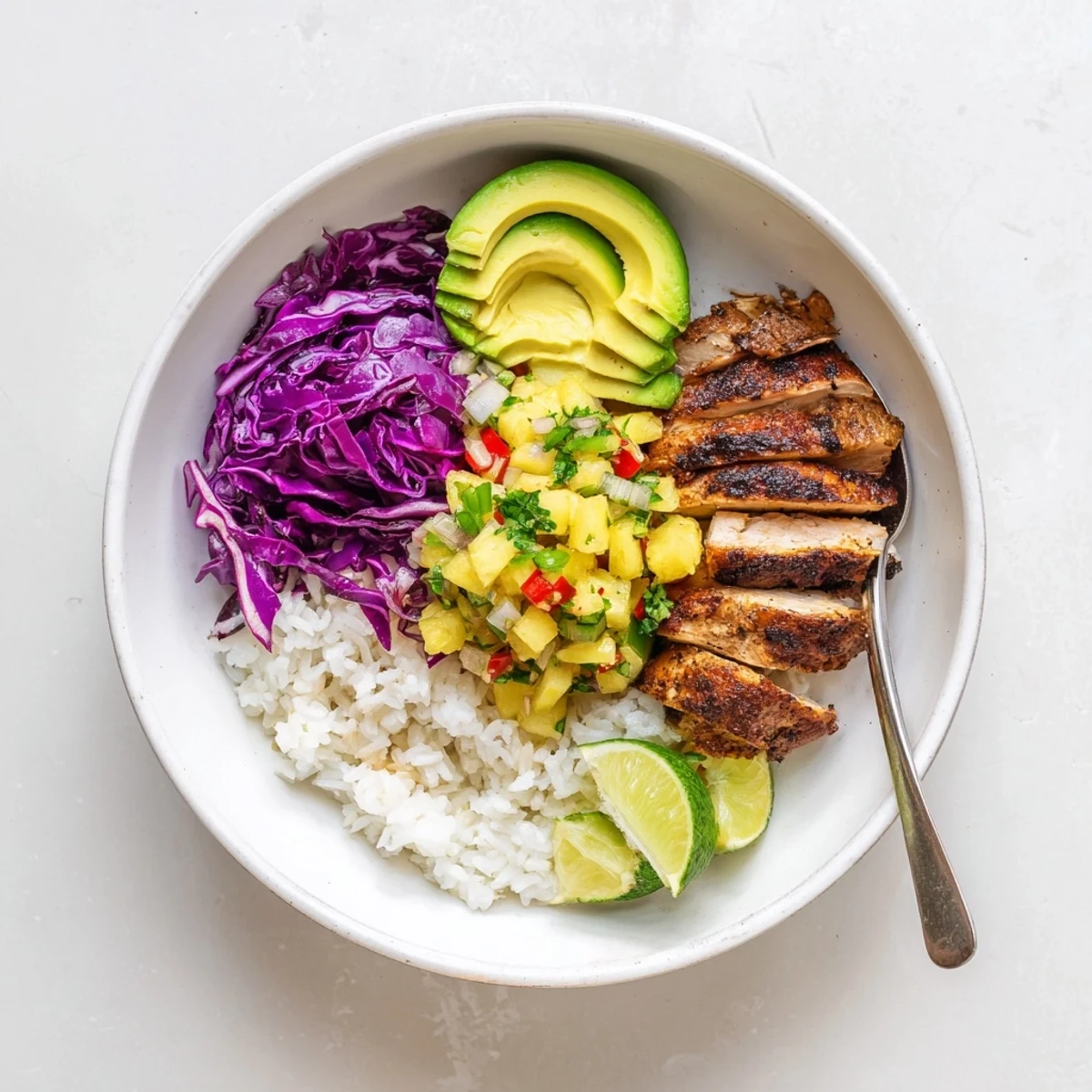 Grilled, slightly charred Jerk Chicken Bowl With Pineapple Salsa, vibrant cilantro garnish.