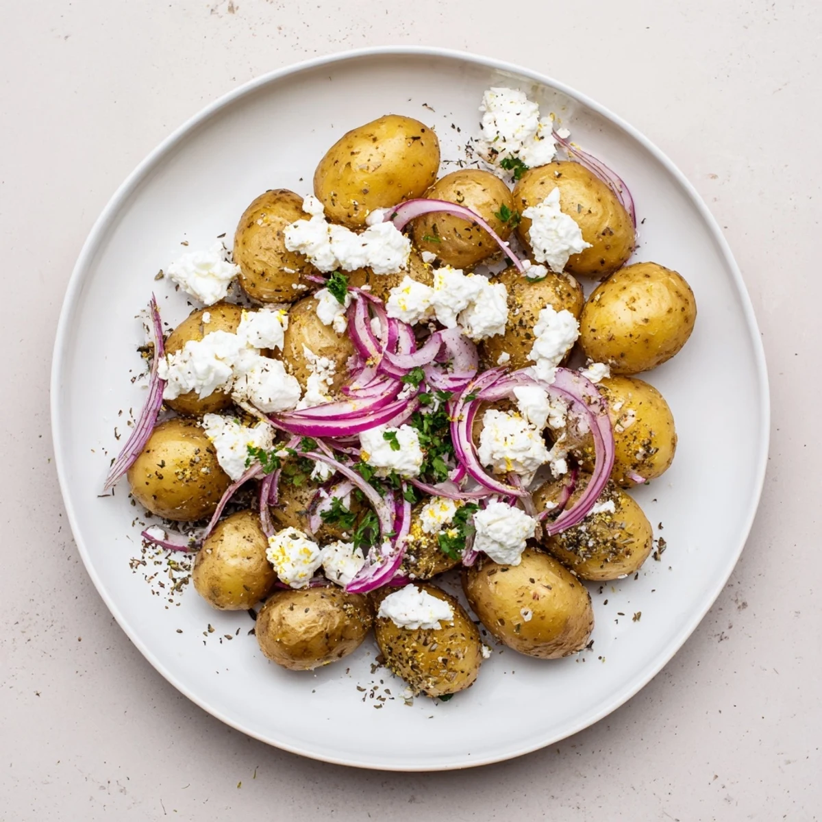 Baked Feta Potatoes with golden roasted skins, creamy feta melting, parsley garnish.