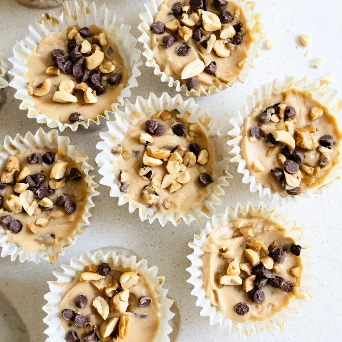 Creamy frozen peanut butter Greek yogurt bites topped with melted chocolate and coconut flakes