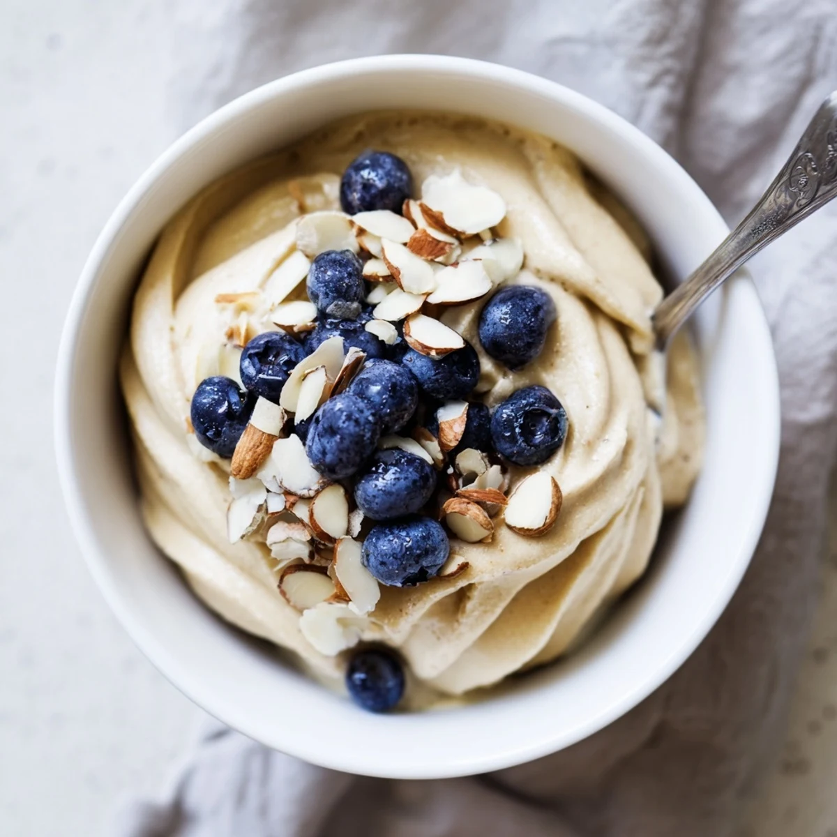 Creamy banana nice cream recipe served in bowls with fresh berry toppings and dark chocolate chips