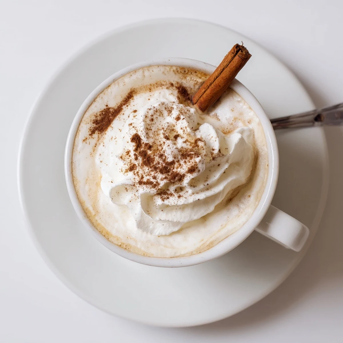 Cozy Winter Lattes steaming in mugs with frothy cream and cinnamon dusting