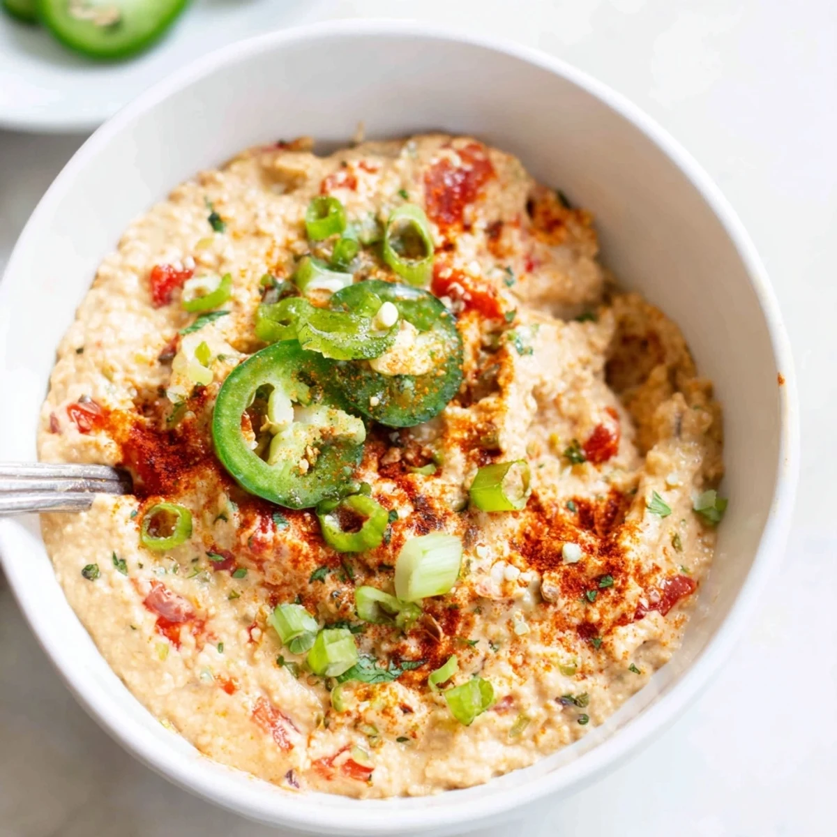 Dairy Free Rotel Nacho Dip bubbling in skillet, creamy, tangy, ready for chips