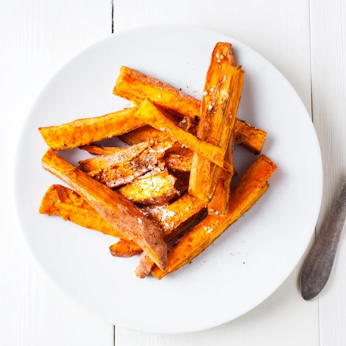 Baked Crispy Oven Sweet Potato Fries sprinkled with smoked paprika, ready for dipping.