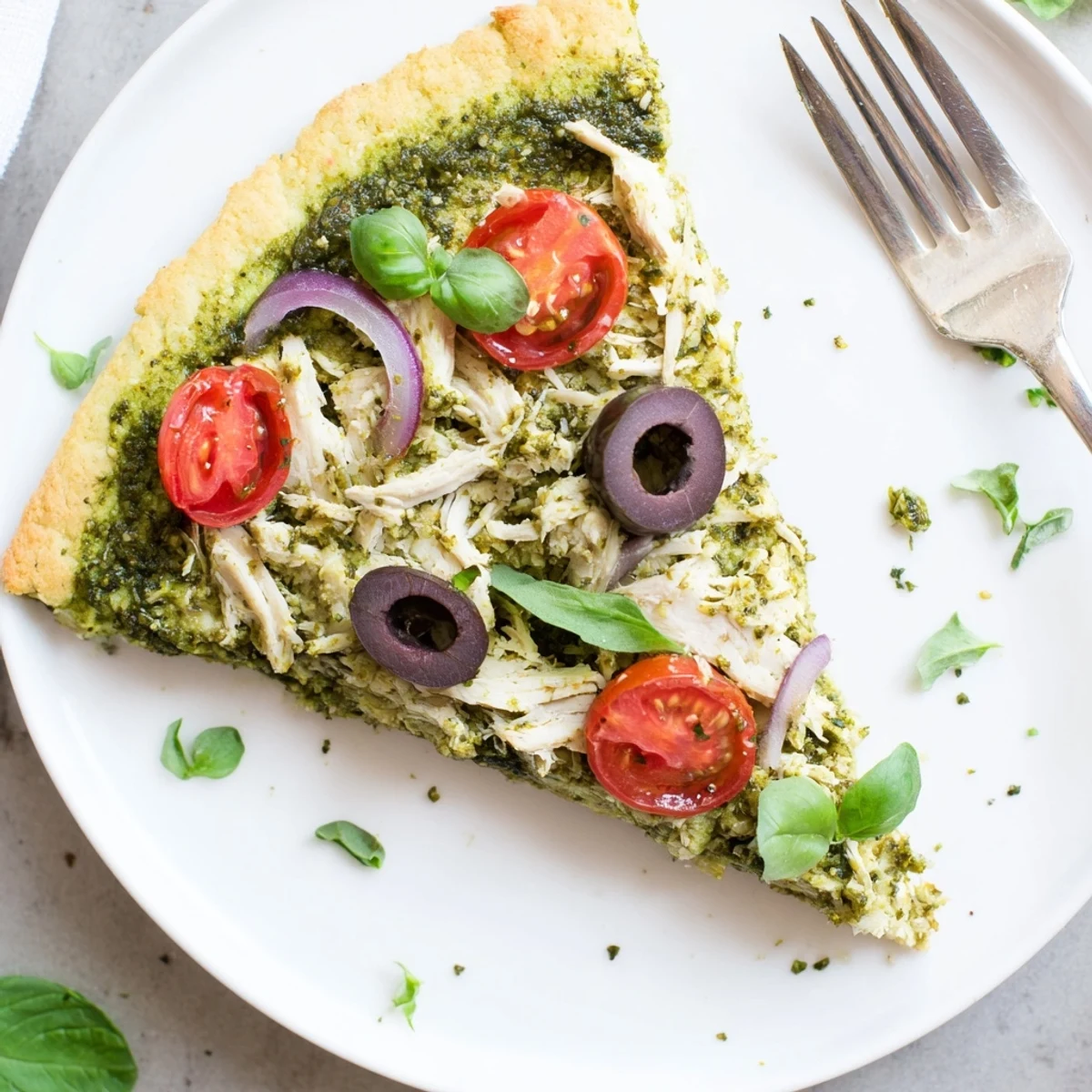 Freshly baked Chicken Pesto Paleo Pizza cooling on parchment, tender chicken, zesty pesto