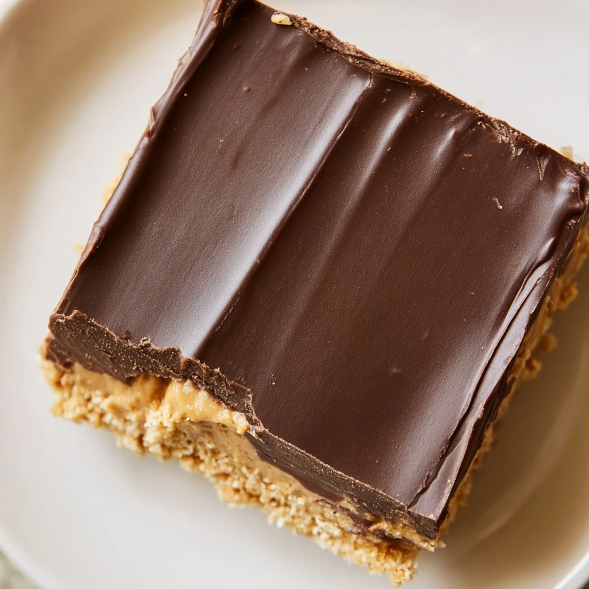 Homemade peanut butter bars featuring creamy peanut butter base and semisweet chocolate layer