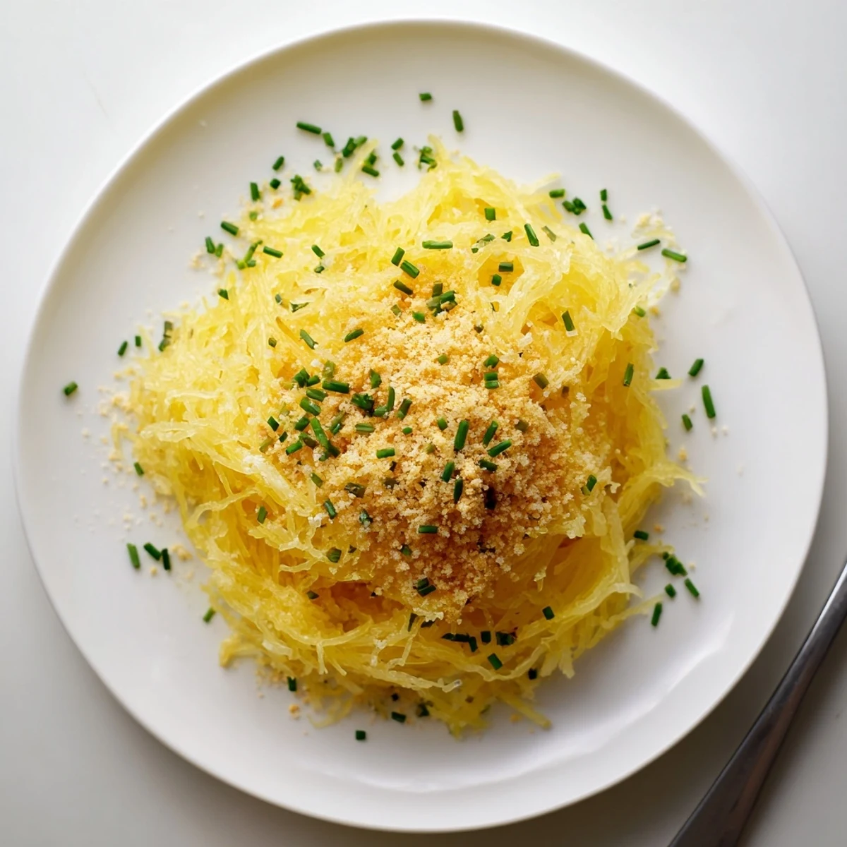 Roasted spaghetti squash strands tossed in rich cheddar Gruyère cheese sauce for a healthier mac and cheese twist