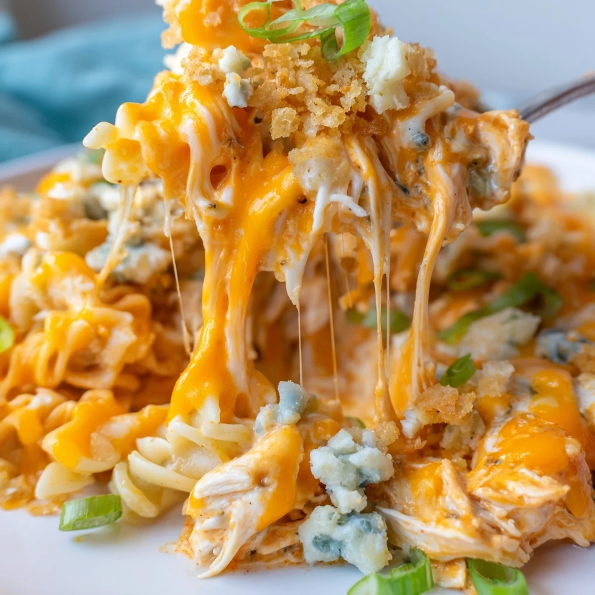 Golden bubbling cheesy buffalo chicken dip casserole fresh from the oven with melted cheese