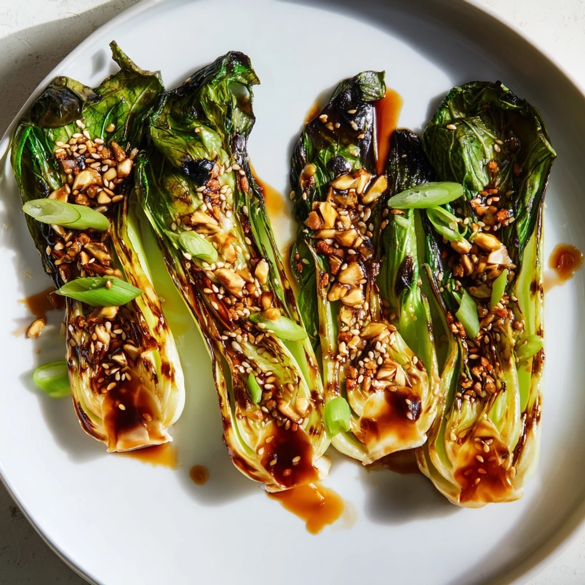 Caramelized garlic bok choy with golden seared edges on a white serving platter