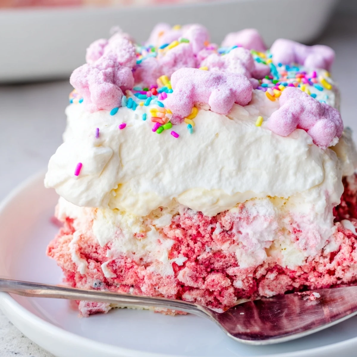 Colorful circus animal cookie lush layered in a chilled glass baking dish