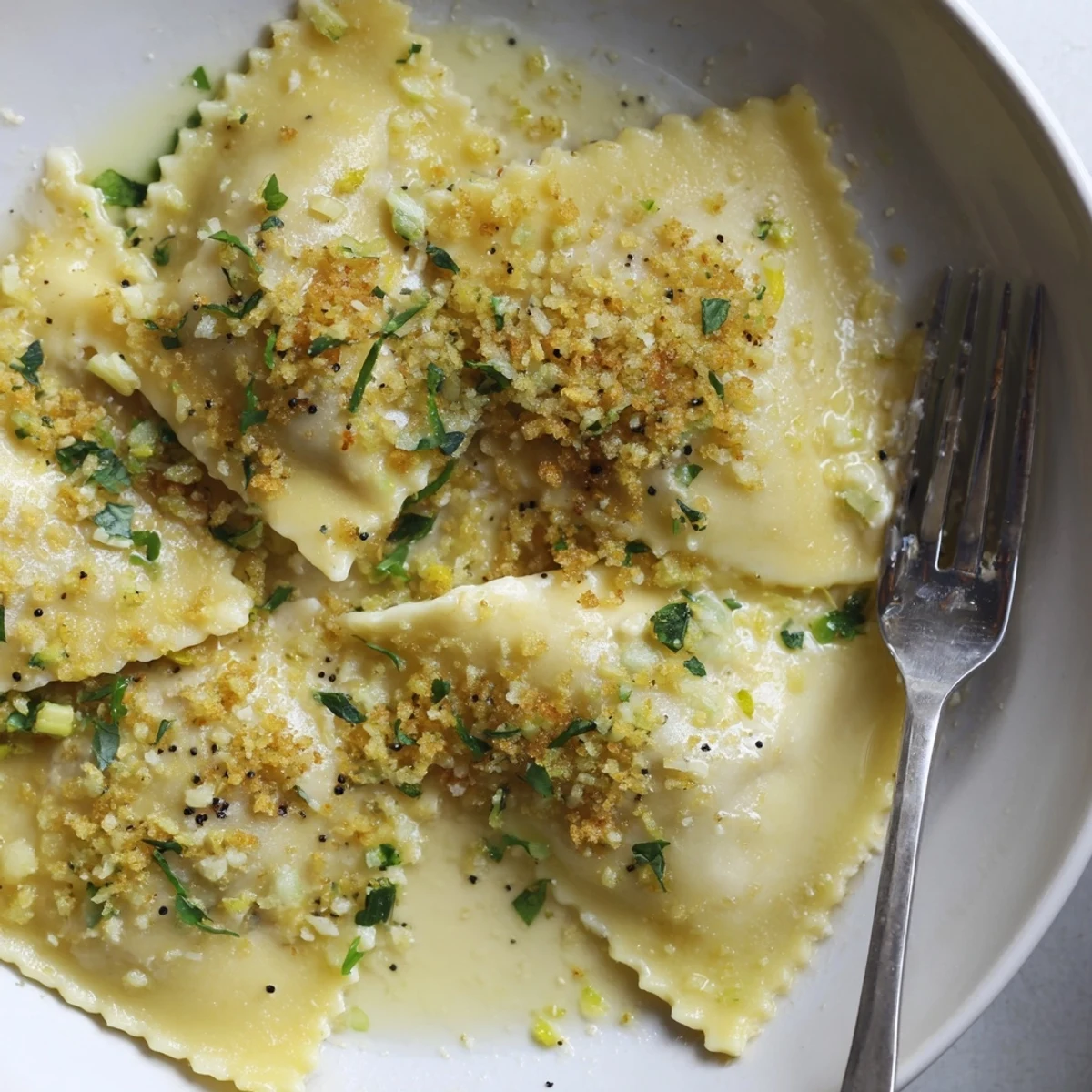 Golden leek burrata triangoli draped in glossy lemon butter sauce with crispy breadcrumbs