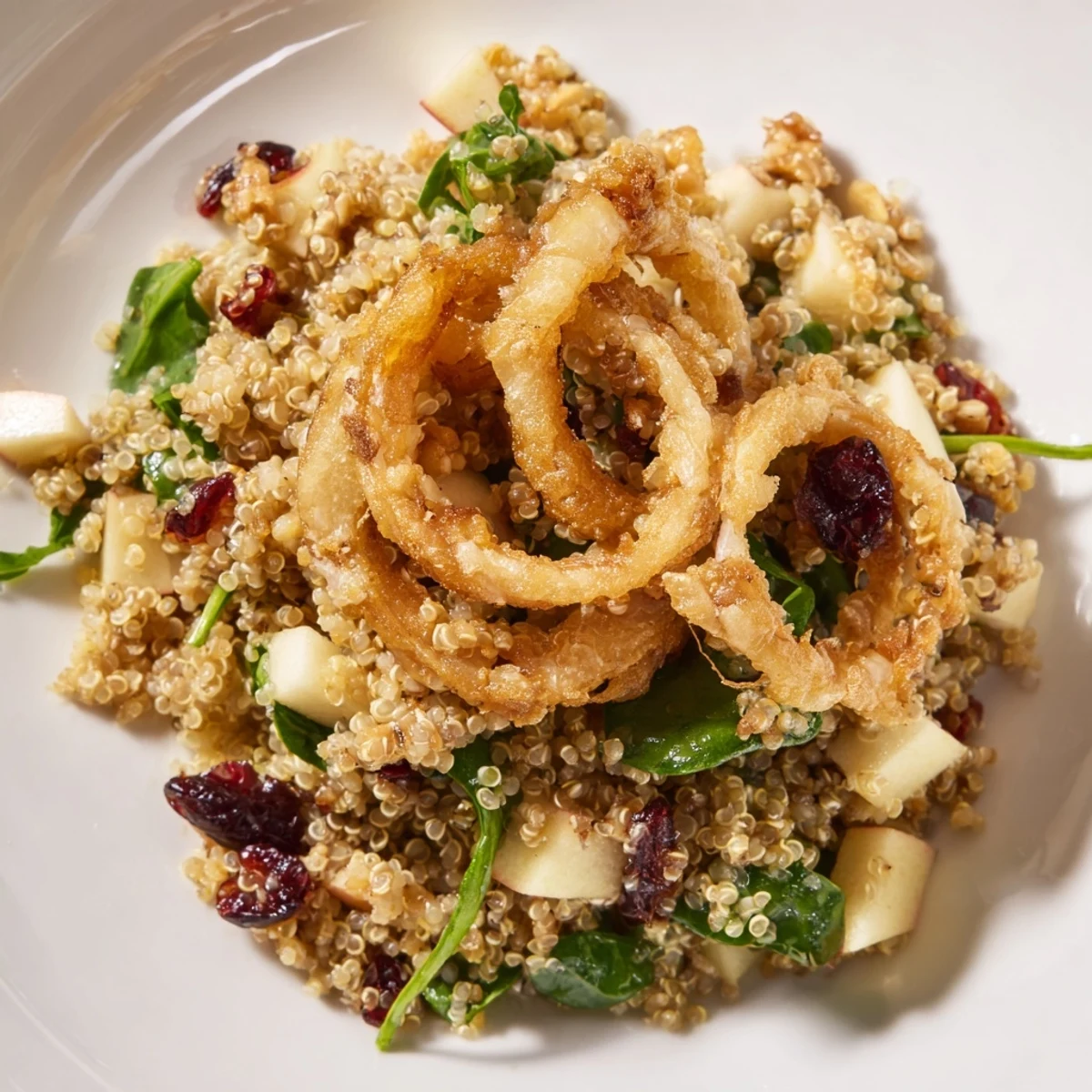 Honey Mustard Quinoa Apple Salad topped with golden crispy shallots on a rustic plate