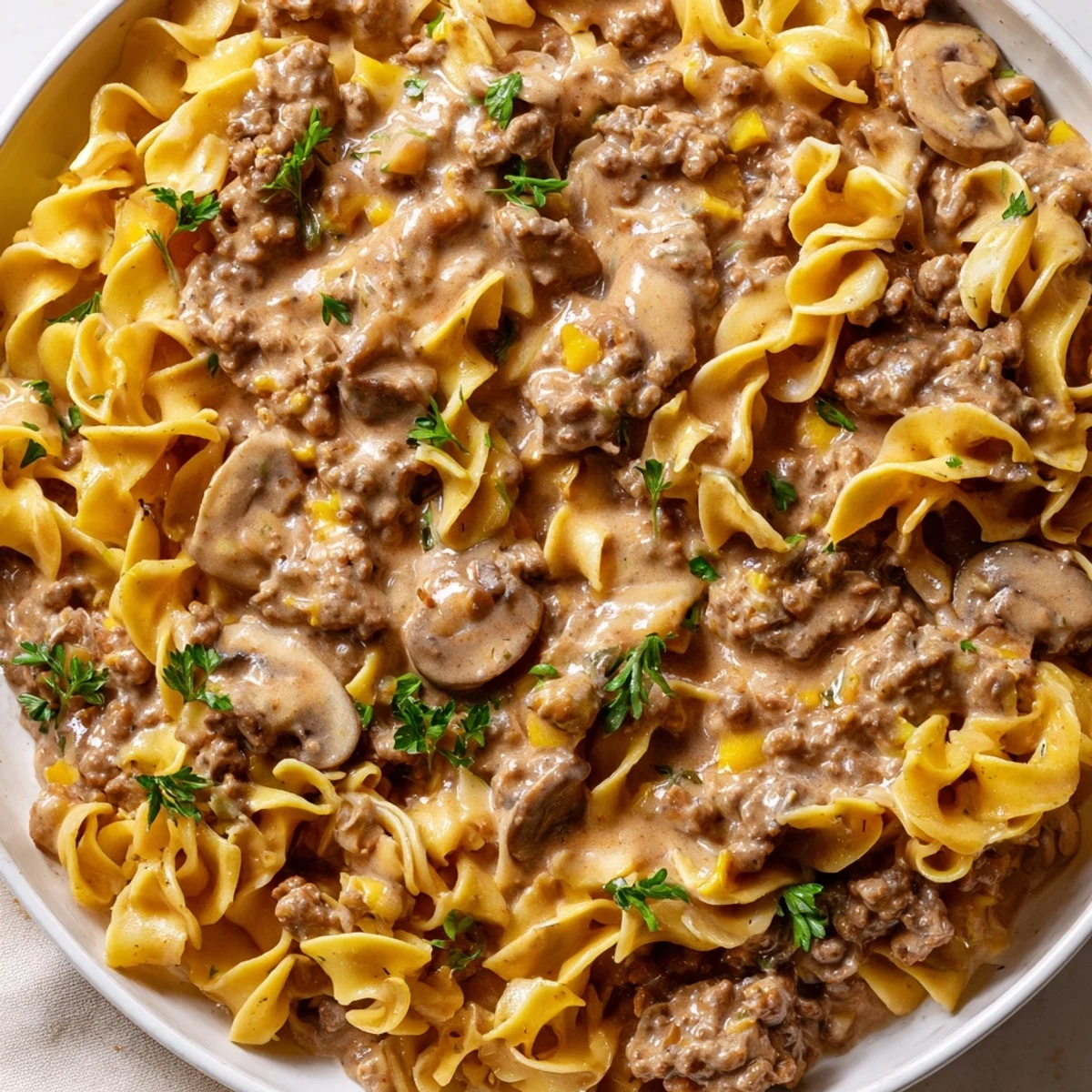 Golden egg noodles coated in savory hamburger stroganoff with mushrooms and sour cream