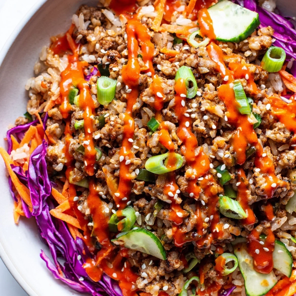 Ground Turkey Rice Bowls drizzled with spicy-sweet Bang Bang sauce and colorful crisp vegetables