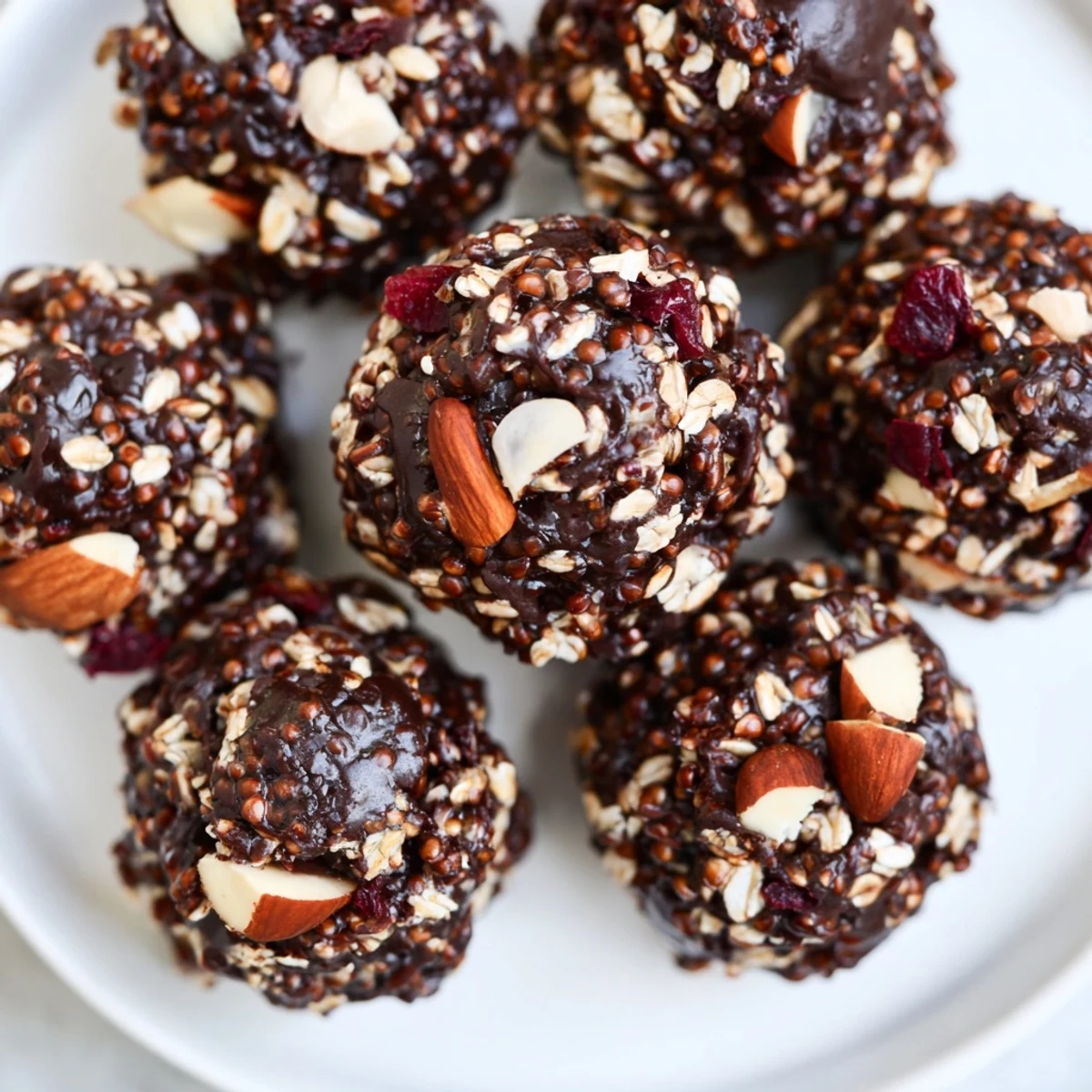 Dark chocolate quinoa crunch bites topped with flaky sea salt on a rustic plate