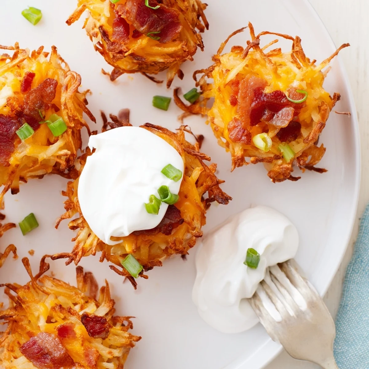Golden crispy Cheesy Loaded Hashbrown Bites fresh from the oven oozing with melted cheddar