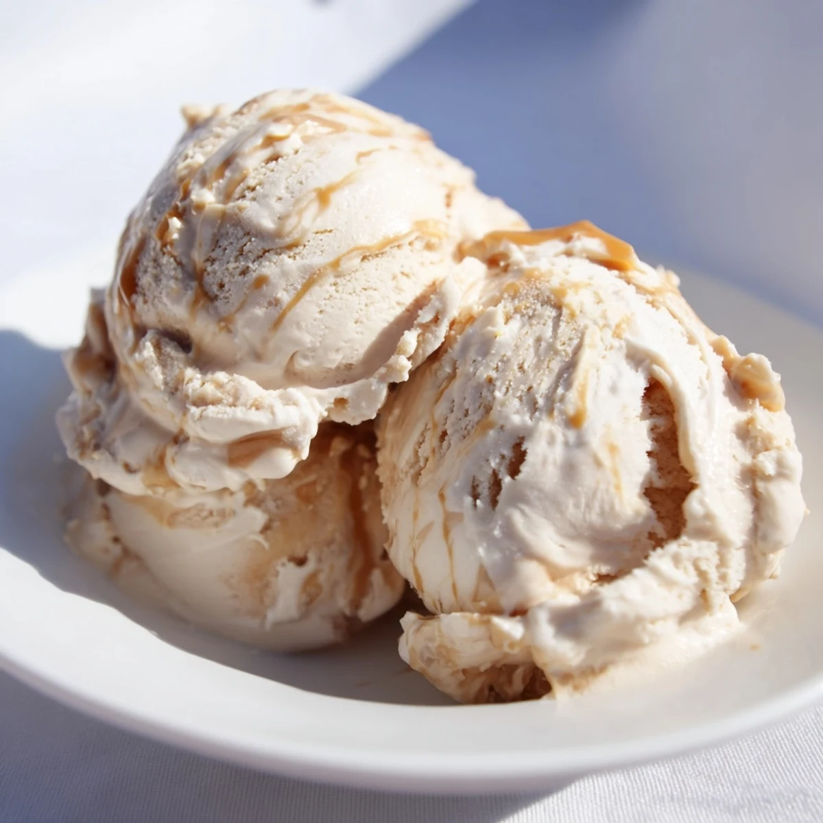 Rich no churn salted caramel ice cream recipe topped with sea salt flakes.